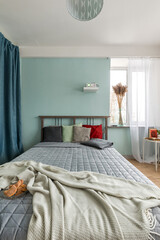 Headboard with pillows. Cozy bedroom in a small apartment