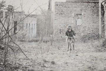 Child and  war. Poor, homeless child in the ruins of a destroyed house. 