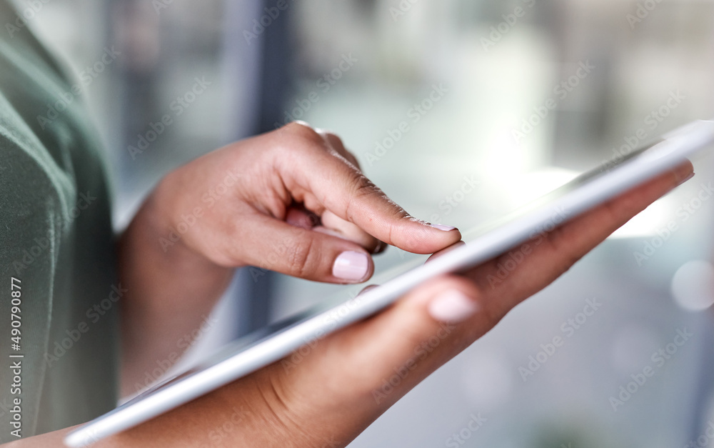 Poster Tap in to a broader world. Shot of an unrecognisable woman using a digital tablet.