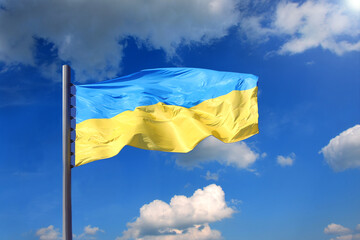 Ukrainian flag against the background of the sky with clouds