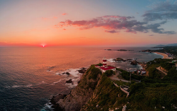 Sunset over a lighthouse at the Maruata beach, Michoacan, Mexico