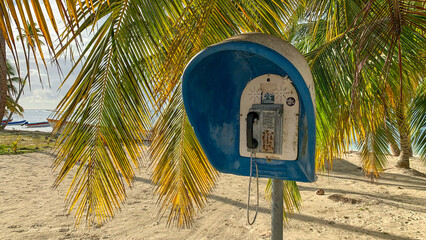Old public payphone on Island Saona in the Dominican Republic - obrazy, fototapety, plakaty