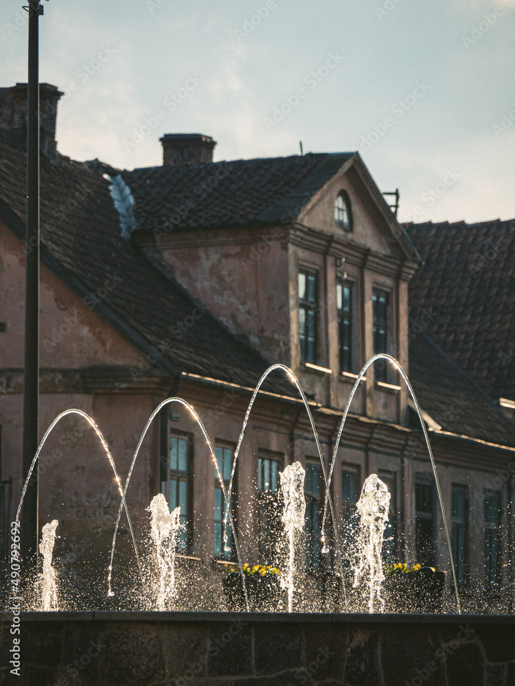 Poster beautiful view of fountains with an old building in a background