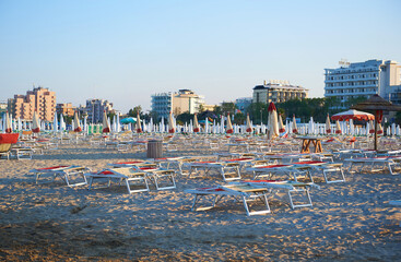 Umbrellas and sunbeds on the beach of Rimini in Italy