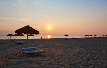 Umbrellas and sunbeds on the beach of Rimini in Italy