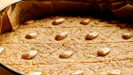 Helbeh fenugreek cake freshly baked in metal tin. Homemade dessert.