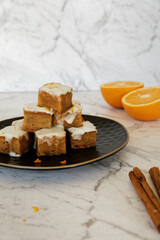 Vegan tofu and carrot cake with frosting. Cut cake cubes in tower.