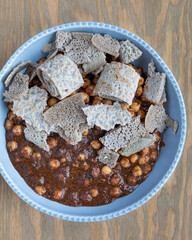 Chickpea with spicy flaxseed sauce meal with pieces of injera flatbread. Ethiopian cuisine homemade dish.