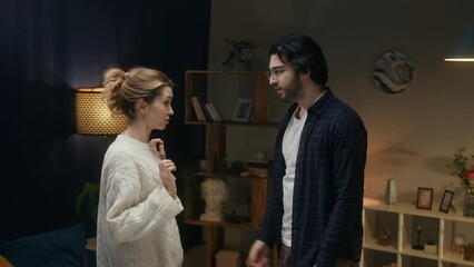 Man and offended woman reconciling, wife forgiving husband. Young couple hugging after conflict. Family problems, crisis in relationships. 