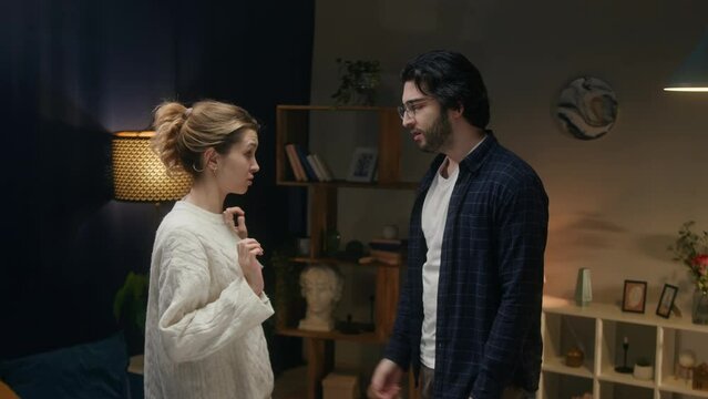 Man and offended woman reconciling, wife forgiving husband. Young couple hugging after conflict. Family problems, crisis in relationships. 