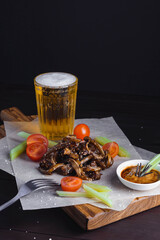 Selective focus on fried ear of pork with tomatoes celery and sauce sprinkled with sesame seeds
