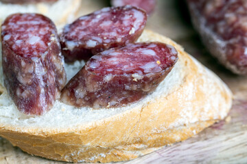 sliced pieces of sausage from meat are lying on a cutting board