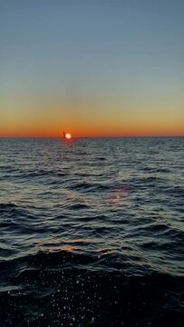 Sailing yaSailing yacht on the background of sunset in the open sea.cht on the background of sunset in the open sea.