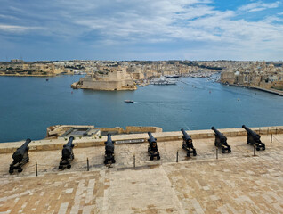 Cityscape view of Birgu with the view of Fort St. Angelo and the sea with boats