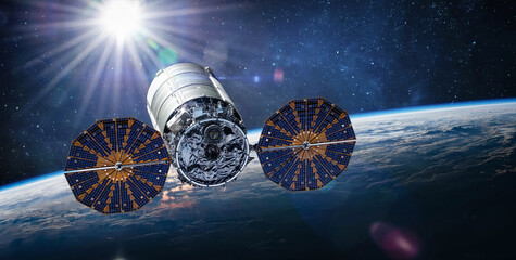 Cygnus spacecraft flight in space. Cygnus on orbit of Earth. Sci-fi wallpaper. Cargo expedition of Antares to ISS space station. Spaceship with astronauts. Elements of this image furnished by NASA 