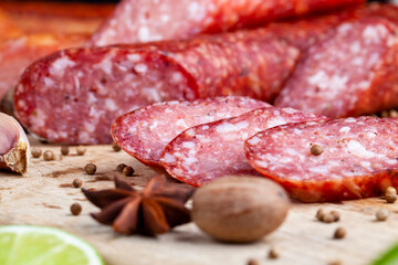 sliced pieces of sausage from meat are lying on a cutting board