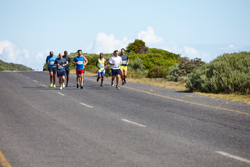 Fototapeta premium They entered this marathon to challenge themselves. Shot of a group of young men running a marathon.
