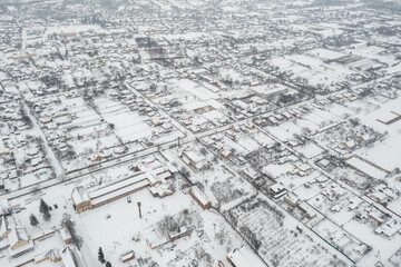 Fototapeta premium Snow-covered village, view from above. houses covered with snow, severe northern frosts