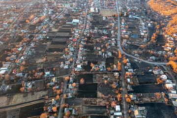 Obraz premium Aerial view of the village, private houses and vegetable gardens