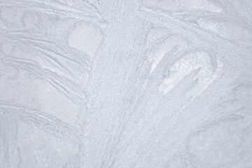 Ice patterns froze on the window. Clean blue background. beautiful texture of nature.
