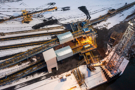 Aerial View Of A Conveyor Belt For Transporting Coal Ore, Storing Coal At A Thermal Power Plant. City Coal Reserves, Conveyor Belts And Excavators In The Snow