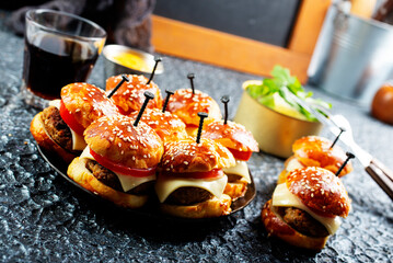 homemade beef burgers with cheese on serving board