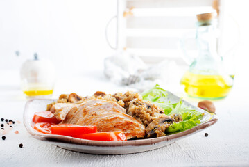Chicken breast with fried mushrooms on plate