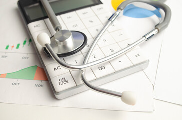 Stethoscope with calculator symbol for health care costs or medical insurance. Health care costs concept.