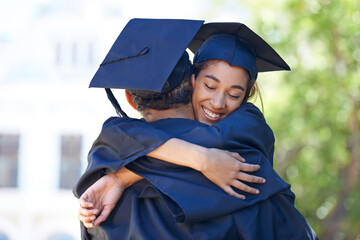 My happiest day. Shot of two happy students embraceing in celebration on graduation day.
