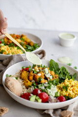 mediterranean buddha bowl with cous cous and tahini