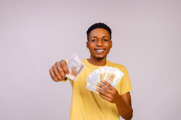 young african boy isolated over white background giving out money