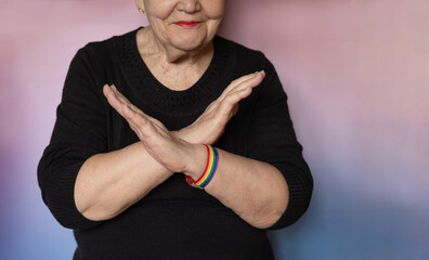 Elderly woman makes a sign BreakTheBias with her arms crossed. International Women's Day. Feminism, International women's day, 8, BreakTheBias. Gender equal, diverse, equitable, and inclusive world
