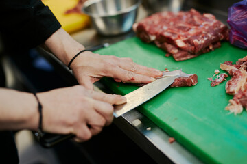 the chef cuts the meat of the lamb