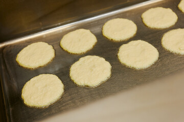 the chef is frying a large batch of pancakes