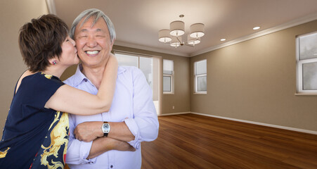 Two Affectionate Chinese Senior Adults In New Empty Room of House.