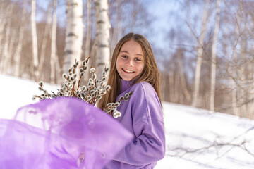 On a sunny spring day, a young girl walks, travels through the forest, collects willow for the Easter holiday. The girl walks among the birches, collects willows, rejoices, laughs, the Easter holiday.