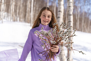 On a sunny spring day, a young girl walks, travels through the forest, collects willow for the Easter holiday. The girl walks among the birches, collects willows, rejoices, laughs, the Easter holiday.