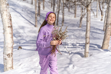 On a sunny spring day, a young girl walks, travels through the forest, collects willow for the Easter holiday. The girl walks among the birches, collects willows, rejoices, laughs, the Easter holiday.