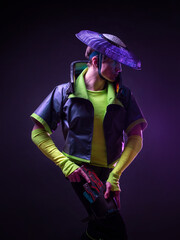 Futuristic character in a bright stylized outfit, photo with neon colors. A fantastic character, a...