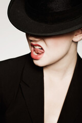 Funky style. An expressive young woman with red lips and a hat.