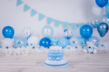 Lovely blue and white birthday cake whit colored balloons and stars.Birthday ideas for kids. Boy...