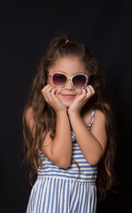 Fototapeta premium smiling caucasian girl with dark glasses portrait on black background 