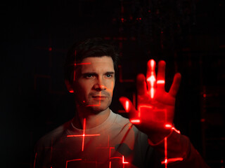Interaction with augmented reality virtual interface, concept. A young man with projections of red...