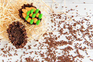 Easter Eggs filled with chocolate on a easter background with sprinkles