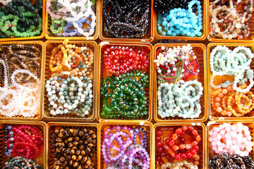 Display of Colourful necklaces in small boxes