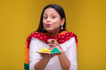 Portraits of young woman celebrating holi