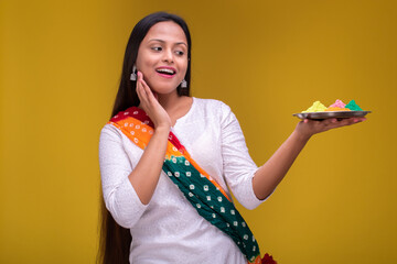 Portraits of young woman celebrating holi