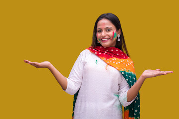 Portraits of young woman celebrating holi