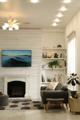 Cozy living room interior with comfortable sofa and decorative fireplace