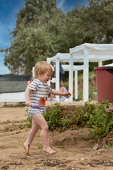 A little boy runs along the sandy beach along the seashore - 490829035